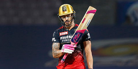Royal Challengers Bangalore skipper Faf du Plessis raises his bat after scoring a half century, during an IPL match against Lucknow Super Giants at the DY Patil Stadium in Navi Mumbai. (Photo| PTI)