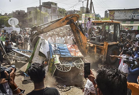 Bulldozers being used to remove illegal structures during a joint anti-encroachment drive by NDMC, PWD, local bodies and the police, in the violence-hit Jahangirpuri area, in New Delhi. (Photo | PTI)