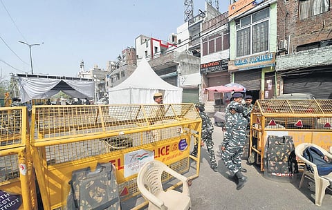 Security personnel guard the violence-hit Jahangirpuri area after the clashes broke out a few days back. (Photo | PTI)