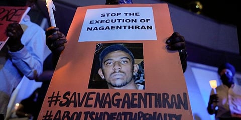 Activists hold posters against the impending execution of Nagaenthran K. Dharmalingam, sentenced to death for trafficking heroin into Singapore. (Photo | AP)