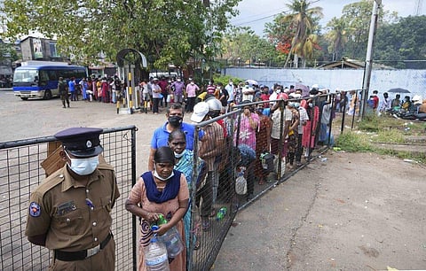 Sri Lankans wait in a queue to buy kerosene oil in Colombo, Sri Lanka. (Photo | AP)