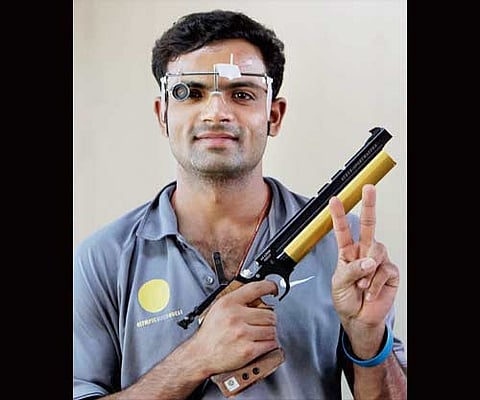 Shooter Vijay Kumar shows the victory sign after winning bronze in men's 10-meter air pistol shooting event. (Photo |PTI)