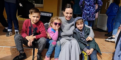Angelina Jolie, Hollywood movie star and UNHCR goodwill ambassador, poses for photo with kids in Lviv. (Photo | AP)