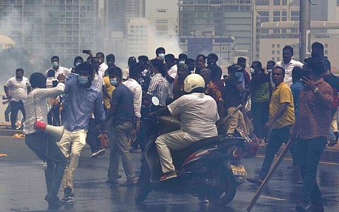 Sri Lanka's pro government and anti government protestors clash amid tear gas outside the president's office in Colombo, Sri Lanka. (File Photo | AP)