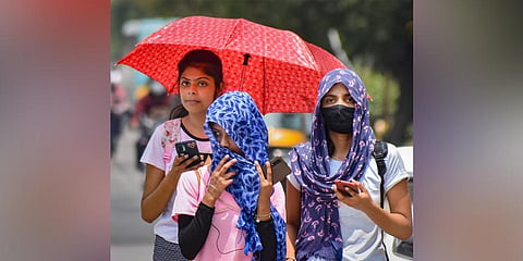Women use scarfs to shield themselves from the heat wave, during a hot summer day in Gurugram. (Photo | PTI)