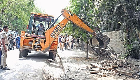 A bulldozer razes a structure during an anti-encroachment drive by  the Municipal Corporation (North) at Vasant Kunj on Tuesday | shekhar yadav