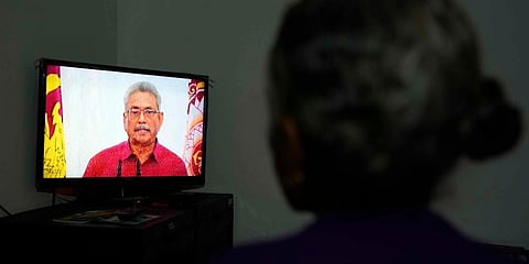 A Sri Lankan woman watches a telecast speech of President Gotabaya Rajapaksa at her house in Colombo. (Photo | AP)