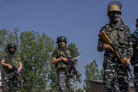 Paramilitary soldiers stand guard near the site where a policeman was shot at in Srinagar on  May 7, 2022. (File | AP)