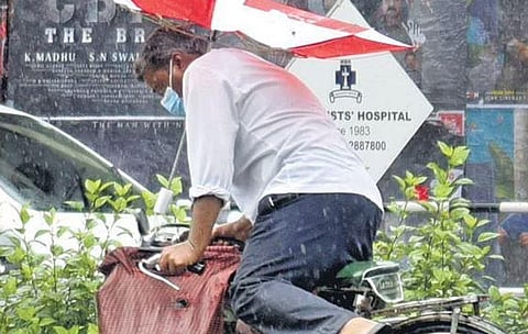 A cyclist struggles to keep his balance as rain lashes parts of Kochi on Thursday, due to the impact of Cyclone Asani | A Sanesh