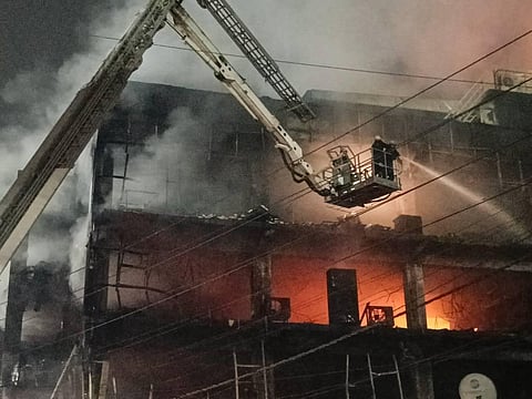 Firefighters try to douse a fire which broke out in a building at Mundka, in West Delhi, Friday, May 13, 2022. (Photo | PTI)