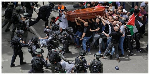 Israeli police confront with mourners as they carry the casket of slain Al Jazeera veteran journalist Shireen Abu Akleh during her funeral in east Jerusalem, Friday, May 13, 2022.  (Photo | AP)