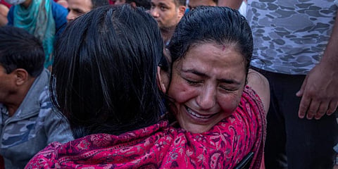 Kashmiri Pandits grieve during a protest against the killing of Rahul Bhat, on the outskirts of Srinagar. (Photo | AP)