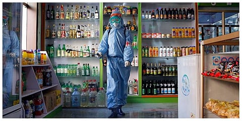 An employee of the Kyonghung Foodstuff General Store disinfects the showroom in Pyongyang, North Korea, Wednesday, Nov. 10, 2021.  (Photo | AP)