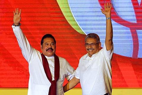 Mahinda Rajapaksa, left, and his brother Gotabaya Rajapaksa wave to supporters during a party convention held to announce Gotabaya's presidential candidacy in Colombo. (Photo | AP)