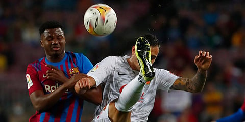 Barcelona's Ansu Fati (L) challenges for the ball with Mallorca's Franco Russo (R) during a La Liga match at the Camp Nou stadium in Barcelona. (Photo| AP)