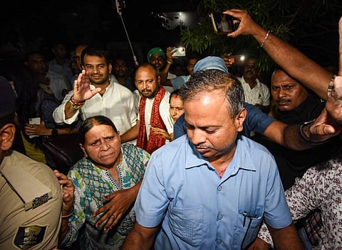 RJD senior leader Rabri Devi and Tej Pratap outside their residence after a raid by CBI in connection with an alleged land-for-jobs scam case, in Patna. 
