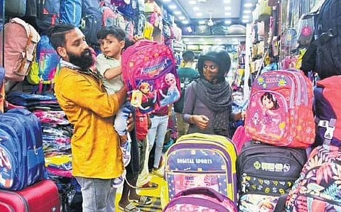 Father and son shop for school bag at Boroadway in Kochi. (Bottom) Workers pack handloom school uniform fabric at the Hantex warehouse in the capital I Sanesh A & B P Deepu