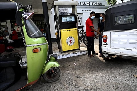 A worker fills the tank of an auto rickshaw at a petrol station in Colombo. (Photo | AFP)