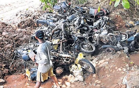 More than a dozen abandoned two-wheelers parked at the entrance of Putharikandam Grounds was buried in a pit by the police  | Vincent Pulickal