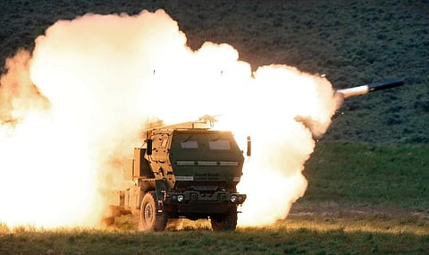 A launch truck fires the High Mobility Artillery Rocket System (HIMARS) produced by Lockheed Martin during combat training. (Photo | AP)