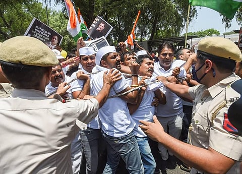 Police detain Youth Congress workers during a protest outside the AICC office against summoning of party leader Rahul Gandhi by the Enforcement Directorate (ED).  (Photo | PTI)