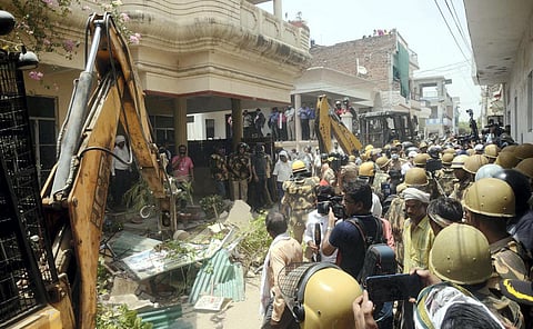 A bulldozer being used to demolish the residence of Javed Ahmed in Prayagraj. (Photo | PTI)
