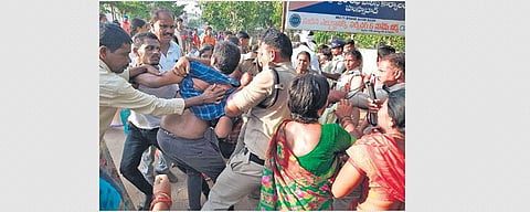 Police try to intervene as the TRS workers clash with protesters from Gudatipalli in Husnabad on Tuesday