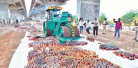 Prakasam police and SEB officials destroying illegal liquor worth `2.14 crore  under the NH-16 flyover in Ongole. (Photo| EPS)
