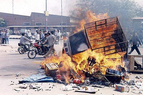 A  vehicle burning during the 2002 Gujarat riots. (Photo | PTI)