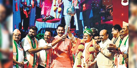BJP state chief Nalin Kumar Kateel hands over the mace to party national president JP Nadda at the state-level convention in Chitradurga on Saturday
