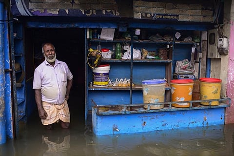 A man stands at the doorway of his flooded shop in Sylhet, Bangladesh. (Photo | AP)