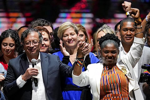 Former rebel Gustavo Petro, left, his wife Veronica Alcocer, back center, and his running mate Francia Marquez, celebrate before supporters after winning a runoff presidential election. (Photo| AP)