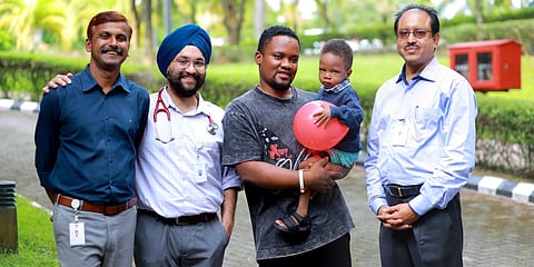 Ifain with his father Abiya and doctors who treated him at Aster Medcity, Kochi. (Photo| Special Arrangement)