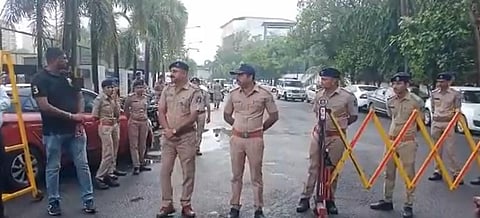 Policemen guard the exterior of Surat's Le Meridien hotel where dissident Sena leader Eknath Shinde is camping along with other MLAs.