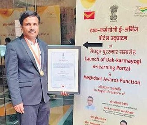 T Dhananjaya, Postal Assistant at the Chief Postal Manager General office in Bengaluru,  is overwhelmed by the honour accorded to him.  (Photo | Express)