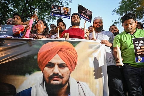 Activists of the Indian Youth Congress (IYC) take out a candlelight march in the memory of Punjabi singer and Congress leader Sidhu Moose Wala, who was shot dead on Sunday. (Photo | PTI) 