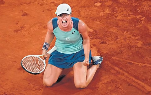 Iga Swiatek reacts after wrapping up her final match against Coco Gauff in the French Open on Saturday  (Photo| AP)