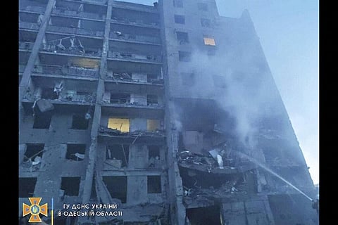 In this photo provided by the Ukrainian Emergency Service, first responders try to extinguish flames at a residential building in Odesa, Ukraine. (Photo | AP)
