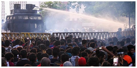 Police use a water canon to disperse demonstrators taking part in an anti-government protest. (Photo | AFP)