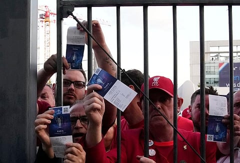 Fans shows tickets in front of the Stade de France prior the Champions League final soccer match between Liverpool and Real Madrid, in Saint Denis near Paris. (File Photo | AP)