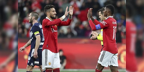 Manchester United's Alex Telles, left, congratulates teammate  Rashford after scoring his team's third goal during the match against Melbourne Victory.(Photo | AP)