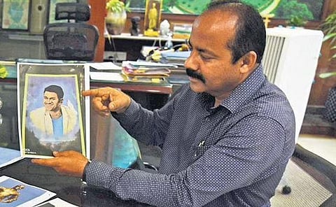 Lalbagh Joint Director M Jagadeesh shows samples of portrait and sketches to be put on display for the Flower Show between August 5 and August 15 | Vinod kumar T