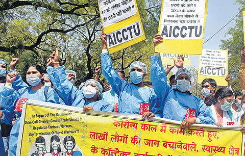 Contractual health workers, who said their contracts were not renewed by the government, shout slogans as they march in support of a nationwide two-day strike in March. (Photo | Kabir Jhangiani)