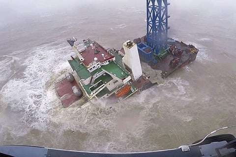 A helicopter with rescue crew members approaches a sinking ship in the South China Sea, 300 kilometers south of Hong Kong, Saturday, July 2, 2022, as Typhoon Chaba was moving in the area. (Photo | AP)