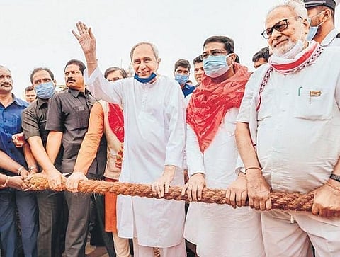 CM Naveen Patnaik waves to the crowd while pulling the Nandighosha chariot. Governor  Ganeshi Lal, Chief Justice S Muralidhar and Union Minister Dharmendra Pradhan also present. (File Photo)