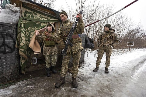 Ukrainian servicemen guard a checkpoint at the line of separation in the Luhansk region, in Luhansk, Ukraine. (Photo | AP)
