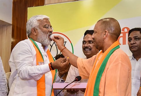 NO SWEET NEWS FOR NOW: In this file photo, CM  Yogi Adityanath and UP BJP chief Swatantra Dev Singh feed each other sweets as they celebrate the party's victory in the bypolls. (PTI)