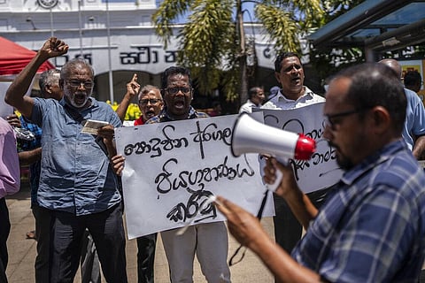 Trade union representatives and activists shout slogans during a protest against Sri Lanka’s acting president Ranil Wickremesinghe in Colombo. (File Photo | AP)