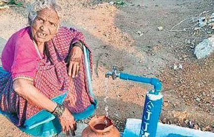 An old woman from Shirahatti fills water