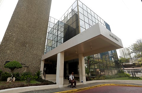 In this file photo a security guard sit outside the Mossack Fonseca law firm in Panama City.  (Photo | AP)